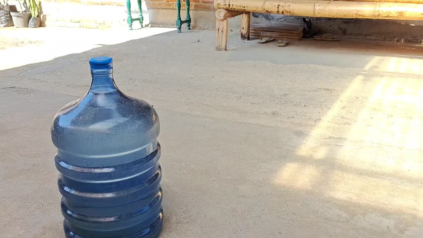 a man is lifting a refillable gallon, very suitable for family and environmental promotional media