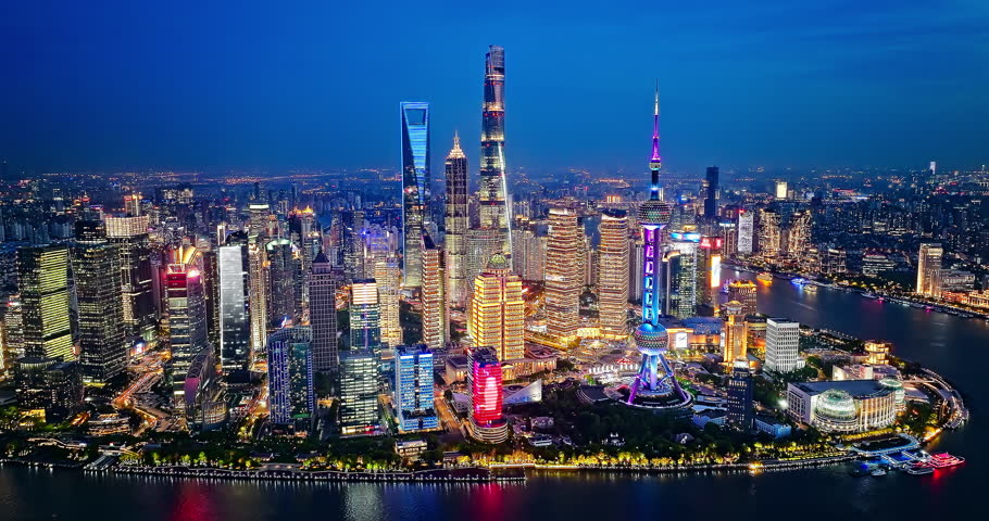 Aerial view of Shanghai skyline and skyscrapers scenery at night, China. Famous city landmarks in China. Drone surround shooting.