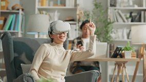 relax casual activity lifestyle woman and man wear wireless virtual headset augmented reality playing sport digital game together at home fun and relax cosy technology at home happiness cheerful game