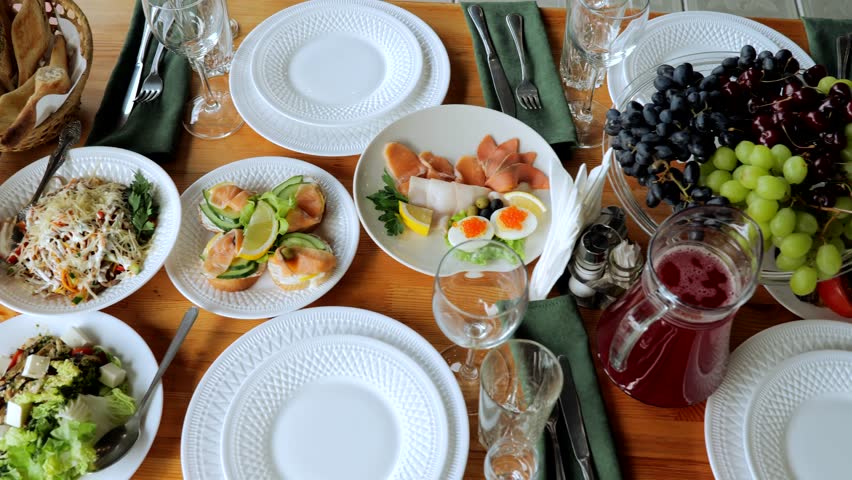 Snack table. Canape with vegetables and cheese, Served table with food. Lots of snacks on the holiday table. Banquet with snacks, cheese and fruits, canapes, salads, appetizers on the festive table.