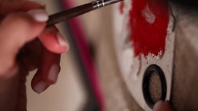 close-up of a makeup artist's hand dipping a bone in red mascara. vertical video - Powered by Shutterstock - Get 15% off with code: PIKWIZARD15