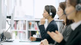 A group of Asian operators wearing headsets to talk to customers in a call center. - Powered by Shutterstock - Get 15% off with code: PIKWIZARD15