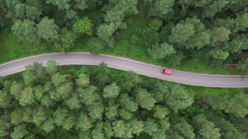Aerial View Red Car Driving Down an Asphalt Road Crossing Vast Forest on Summer Day. Aerial Shot of Car Driving on Road in Pine Tree Forest. Road Trip Through Forest. Scenic Summer Landscape. | Shutterstock HD Video #1111564123