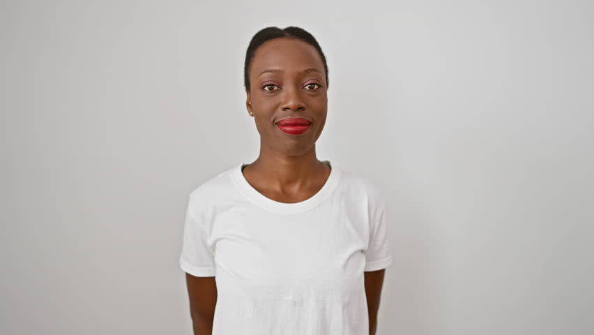 Smiling african american woman reveling in joy, confidently pointing at herself against a sleek, isolated white background