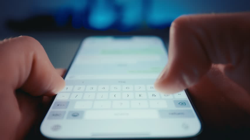 Point of view closeup shot of man hands holding smartphone and typing on touch screen. People chat online in social media. Concept of internet communication. 