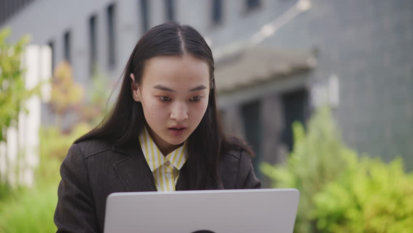 Asian Woman is Overexcited Reading Good News on her Laptop. Cheerful businesswoman receiving great job offer. Female winning online. | Shutterstock HD Video #1111571919
