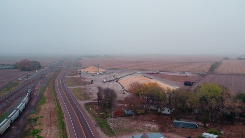 rising aerial of temporary granary storage. Moody day, Chapman, NE, USA