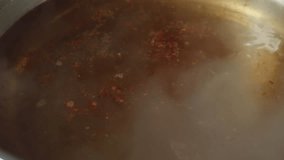 Close Up Of Chili Being Sprinkled Into The Boiling Soup Pot. Sukiyaki Or Shabu - Powered by Shutterstock - Get 15% off with code: PIKWIZARD15