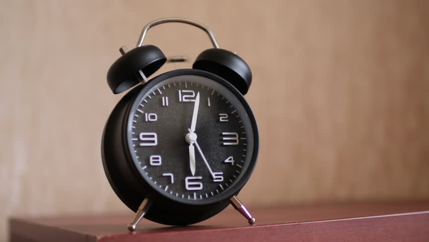 Alone retro alarm clock indoor. A retro clock ringing in the morning on the bedside table in the room.