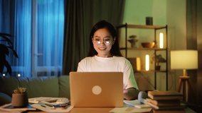 Beautiful young asian woman having video call conference meeting interview by laptop computer at home Confident female talking on working conversation having distance remote job at late night indoors