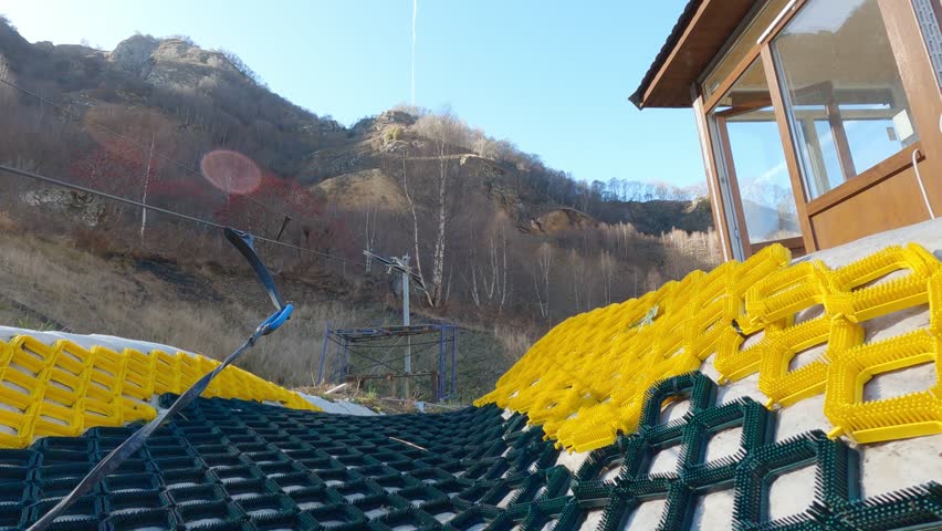 A man descends on an inflatable sled from an all-season tubing slide. Extreme entertainment for the whole family. first person photography