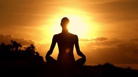 person meditation yoga silhouette with view of epic dark clouds flying into camera, Nature landscape in motion. revealing scenic sunset sun setting into horizon. Timelapse, 4K UHD.