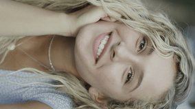 Close up portrait of smiling woman laying in park - vertical video, cedar hills, utah, united states - Powered by Shutterstock - Get 15% off with code: PIKWIZARD15