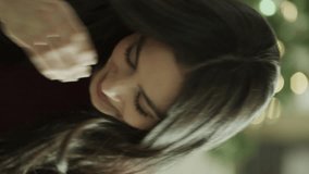 Close up portrait of smiling woman near christmas tree - vertical video, orem, utah, united states - Powered by Shutterstock - Get 15% off with code: PIKWIZARD15