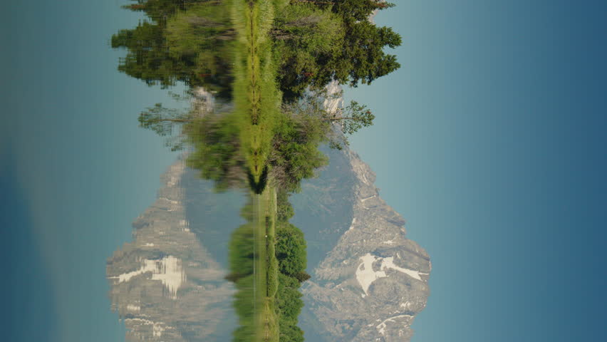 Reflection of mountain range in scenic snake river - vertical video, grand teton national park, wyoming, united states
