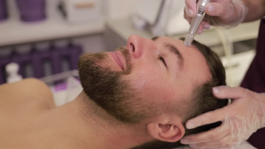 Facial rejuvenation procedure in a beauty clinic using modern medical equipment. A man in a spa beauty salon Royalty-Free Stock Footage #1111584043