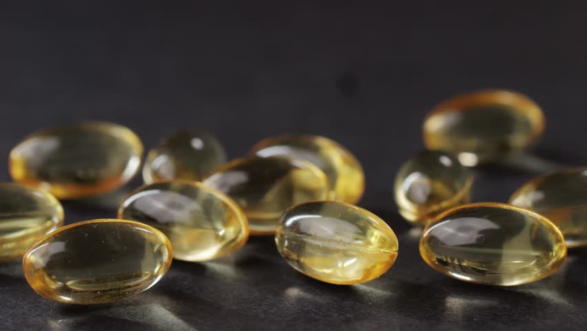 Omega fish oil gel capsules on black background close-up . Omega vitamins pills 3 6 9. To be healthy and take care of your health. Pharmaceutical industry. Business of biological supplements and | Shutterstock HD Video #1111589827