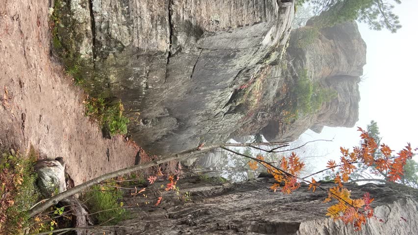 Stone City in autumn. Bright foliage and autumn landscape. The natural landscape is a rock formation in Central Russia, the Urals. A natural monument. Ancient rocky folding in the Ural Mountains. 4K