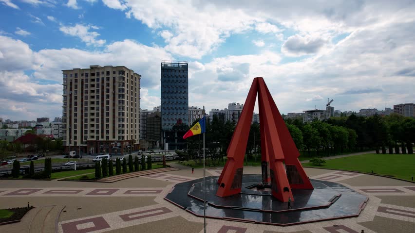Panoramic aerial drone view of Eternity Memorial Complex in park of military glory, dedicated to Great Patriotic War. Pyramid of red stone, 5 rays of which are stylized as rifles. Chisinau, Moldova.4K