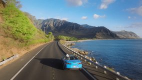 Aerial view sport car with tourist. Road trip, summer adventure. Beautiful nature of Hawaii tropical island in Pacific ocean. Blue convertible car driving on scenic road by West coast on Oahu island - Powered by Shutterstock - Get 15% off with code: PIKWIZARD15