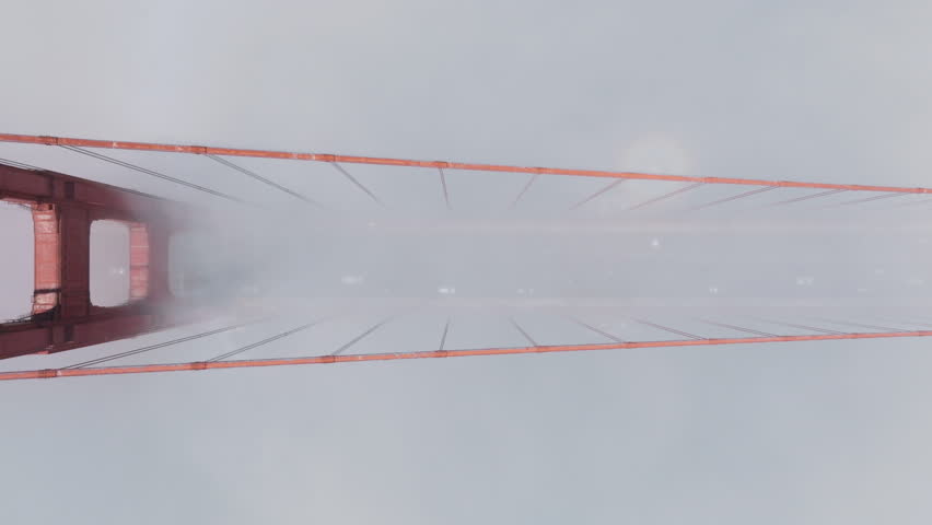 Aerial view of vehicles driving on route 101 in thick fog, Golden Gate Bridge, San Francisco, California, USA. Top view of cars moving fast on red suspension bridge in the morning most, 4k footage  Royalty-Free Stock Footage #1111595215