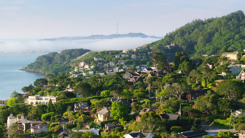 Aerial view of Sausalito landscape with cute houses at the Pacific Ocean, San Francisco area, California, West coast, USA. Breathtaking shot of San Francisco suburban with Golden Gate bridge in fog