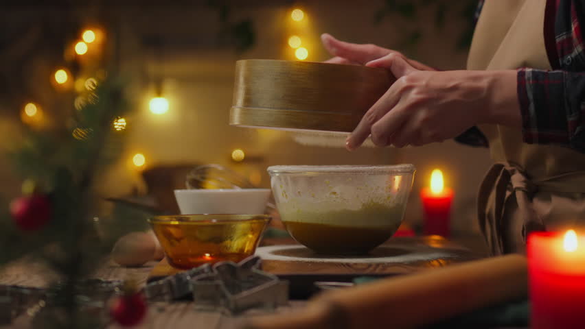 Sweet food. Skillful housewife in kitchen clothes preparing homemade cookies for Christmas on the kitchen table. Attentive housewife prepares baked goods at home, observes rituals, thanksgiving day Royalty-Free Stock Footage #1111596485