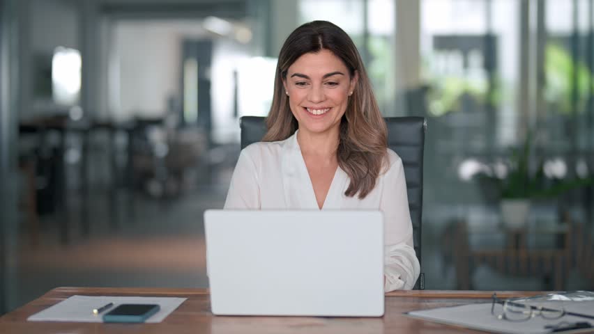 Happy mature business woman entrepreneur in office using laptop at work, smiling professional middle aged 40 years old female company executive wearing suit working on computer at workplace. | Shutterstock HD Video #1111597261