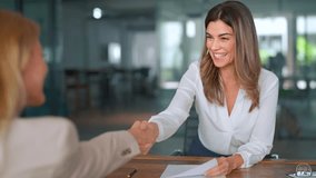 Happy mid aged business woman manager handshaking at office meeting. Smiling female hr hiring recruit at job interview, bank or insurance agent, lawyer making contract deal with client at work. - Powered by Shutterstock - Get 15% off with code: PIKWIZARD15