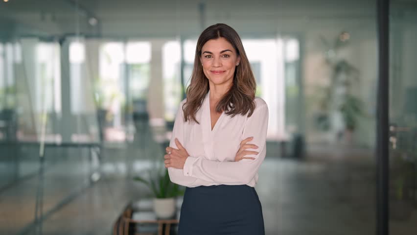 Smiling confident 45 years old Latin professional middle aged business woman corporate leader, happy mature female executive, lady manager standing in office looking at camera, portrait. | Shutterstock HD Video #1111597269