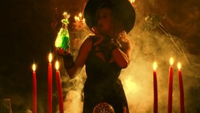 art fantasy woman witch creates magic dark gothic room full smoke candle fire. evil mystical girl holds in hands glowing bottle poison potion. Carnival costume witch magician black dress pointed hat  - Powered by Shutterstock - Get 15% off with code: PIKWIZARD15