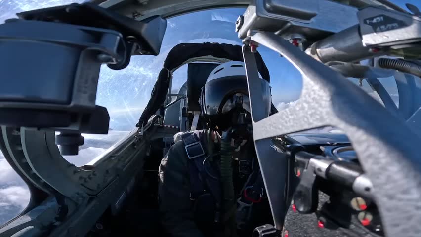 Ukrainian pilot in a helmet inside the cockpit of a fighter