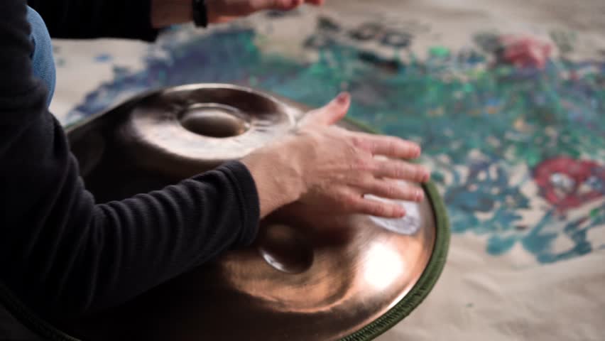 Hands with hang drum close up, man practicing meditation music 