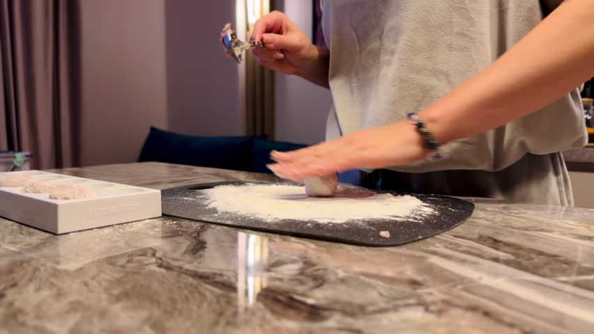 girl rolls minced meat in flour to make cutlets. High quality FullHD footage
