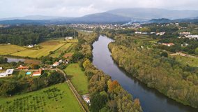 Stunning aerial 4K drone footage of a Ponte de Lima and its river the Lima River in Portugal. Filmed in autumn during partly cloudy weather.