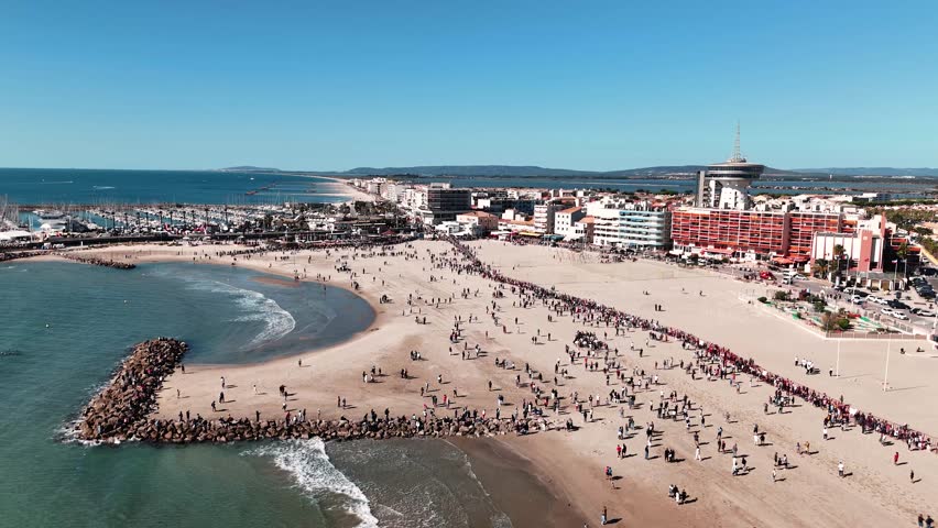 Aerial shot of a crowded beach watching horses run across during the feria in France Royalty-Free Stock Footage #1111627413