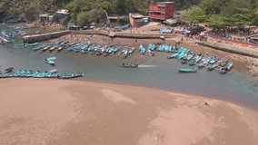 Aerial view of moving fishing boats on the harbor. Indonesia traditional fisherman - Baron beach, Indonesia