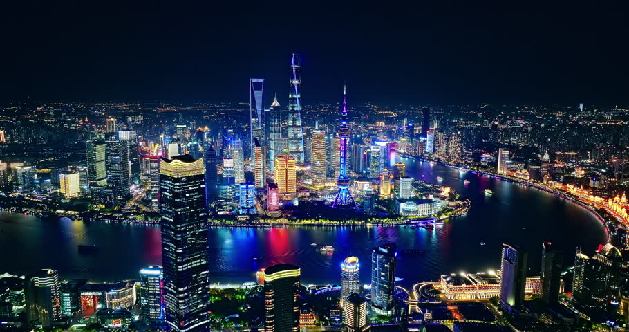 Aerial view of Shanghai skyline and skyscrapers scenery at night, China. Famous city landmarks in China. Drone surround shooting.