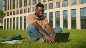 Happy smiling African American man university college academy student guy teenager male studying homework online on grass meadow in park study learning with book copybook laptop prepare for exam study - Powered by Shutterstock - Get 15% off with code: PIKWIZARD15