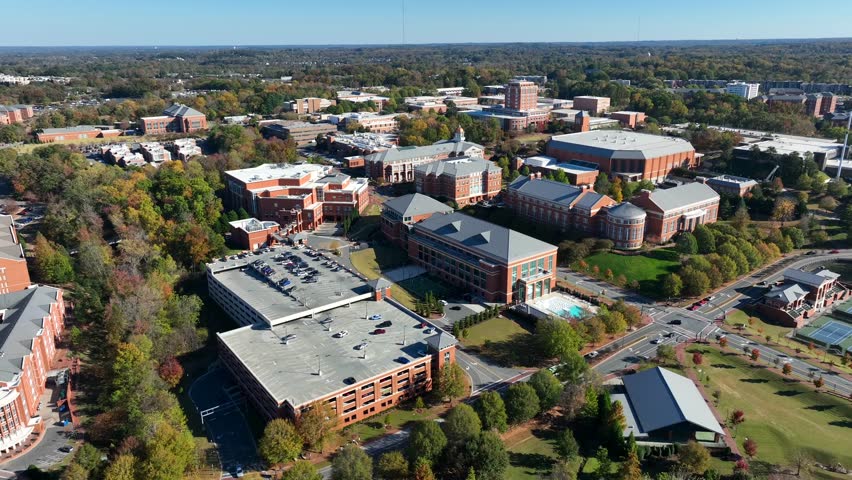 UNC Charlotte campus. High aerial establishing shot of University of North Carolina dorms and academic buildings on autumn day.