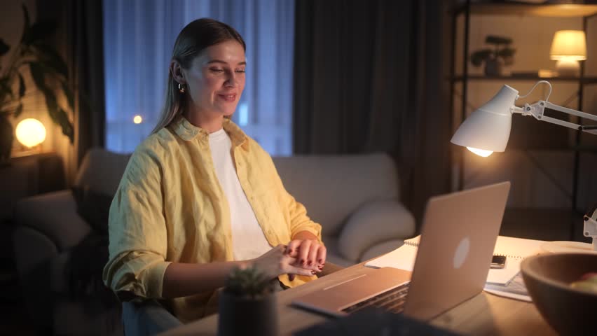 Beautiful young blonde woman having video call conference meeting interview by laptop computer at home Confident female talking on working conversation having distance remote job at night indoors | Shutterstock HD Video #1111635075