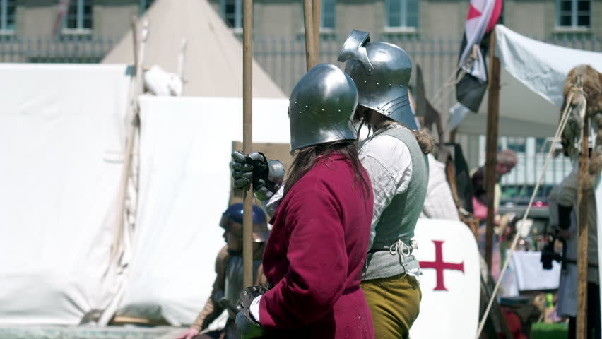 Defenders of History of Poised Soldiers with Spears at Reenactment Medieval Gathering