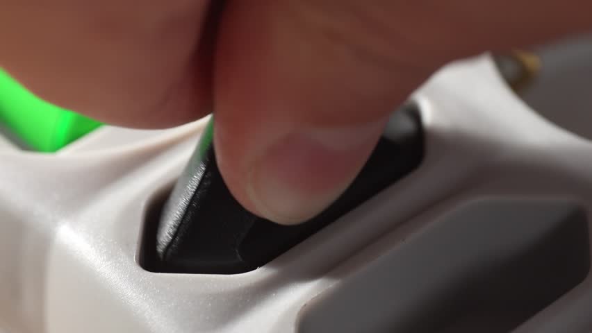 Inserting Plug into Surge Protector. Close-up, shallow dof.
