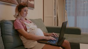 Pregnant woman working late hours at computer at home. Workaholic pregnant working at night online. - Powered by Shutterstock - Get 15% off with code: PIKWIZARD15