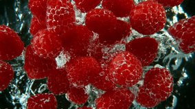 Super slow motion shot of falling raspberries into water, black background, underwater point of view. Filmed on high speed cinematic camera at 1000 fps. - Powered by Shutterstock - Get 15% off with code: PIKWIZARD15