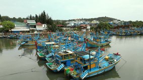 Footage from the drone view from the shore on the Several dozen Asian fishing boats, aerial view of Mui Ne's huge fishing fleet bringing seafood to central Vietnam. 4K