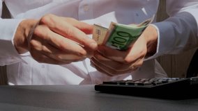 Expert trader hands showing Bitcoin coin digital gold after counting income banknotes of euro cash on calculator. Close up of hands unrecognizable Freelancer. Earned trading charts growth - Powered by Shutterstock - Get 15% off with code: PIKWIZARD15