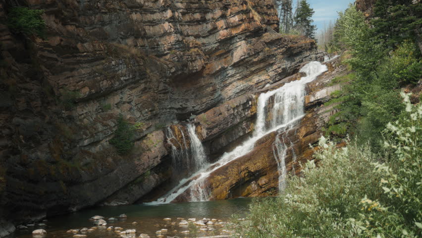 Beautiful Cameron Falls waterfall in Waterton National Park,. Alberta, Canada. Slow motion.