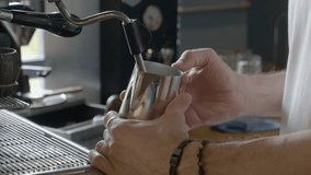  The coffee machine is frothing milk. Barista's hands hold a jug of milk. - Powered by Shutterstock - Get 15% off with code: PIKWIZARD15