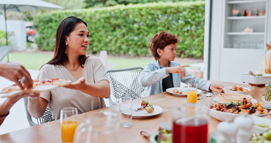 Family, serve and food at table for lunch, party or event with unity, bonding and conversation in home. People, pizza and salad with beverage or support with dinner, nutrition and meal in dining room